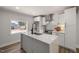 Stylish kitchen with island, granite countertops, stainless steel appliances, and white cabinets at 2207 Edwin Ave, Durham, NC 27705