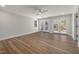 Bright living room with wood floors, ceiling fan, and double doors to the outside at 2207 Edwin Ave, Durham, NC 27705