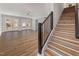 Open-concept living room featuring wood floors and a staircase with a black railing at 2207 Edwin Ave, Durham, NC 27705