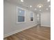 A living room with recessed lighting, wood flooring, and bright windows at 2207 Edwin Ave, Durham, NC 27705