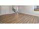 A living room with wood floors, white trim, and access to the staircase at 2207 Edwin Ave, Durham, NC 27705