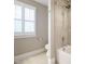 The bright bathroom features white trim, natural light from the window, and a white tub with a shower head at 505 Annandale Dr, Cary, NC 27511
