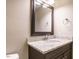 Neutral bathroom featuring granite countertops, a vanity with dark wood cabinets, and a decorative mirror at 505 Annandale Dr, Cary, NC 27511
