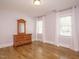 A bedroom with hardwood floors, natural light, and a classic wooden dresser, offering comfort and style at 505 Annandale Dr, Cary, NC 27511