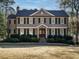 Charming two-story home with a manicured lawn, mature trees, and classic architectural details at 505 Annandale Dr, Cary, NC 27511