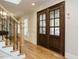 Elegant foyer with hardwood floors, wainscoting, and a staircase with wrought iron railings at 505 Annandale Dr, Cary, NC 27511