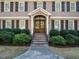 Inviting front entrance with stone steps, a covered porch, and a beautifully crafted wooden door at 505 Annandale Dr, Cary, NC 27511