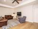 Spacious living room with hardwood floors, ceiling fan, recessed lighting, and comfortable seating on a patterned area rug at 505 Annandale Dr, Cary, NC 27511
