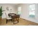 Bright office space with wainscoting, a modern desk, and natural light from the two windows at 505 Annandale Dr, Cary, NC 27511