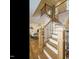 Beautiful staircase with hardwood steps, black iron railings and sunlit open-concept living space at 505 Annandale Dr, Cary, NC 27511