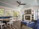 Cozy sunroom featuring a fireplace, comfortable seating, and views of the surrounding trees at 505 Annandale Dr, Cary, NC 27511