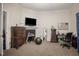 Bright bedroom with a dresser, desk, and large TV at 607 Young St, Henderson, NC 27536