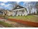 Charming craftsman style home with a front porch and well-manicured lawn at 607 Young St, Henderson, NC 27536