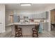 Modern kitchen with gray cabinets, an island, and stainless steel appliances at 607 Young St, Henderson, NC 27536
