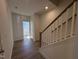 Inviting entryway featuring hardwood floors, white trim, and staircase at 6332 Granite Quarry Dr, Raleigh, NC 27610