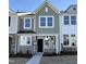 Charming two-story townhome with a modern design, a welcoming entrance, and newly installed landscaping at 6332 Granite Quarry Dr, Raleigh, NC 27610