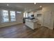 Bright kitchen featuring a granite island, stainless appliances, and hardwood floors at 6332 Granite Quarry Dr, Raleigh, NC 27610
