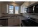 Stylish kitchen featuring white cabinets, stainless steel appliances, and granite countertops at 6332 Granite Quarry Dr, Raleigh, NC 27610