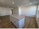 Spacious living room featuring hardwood floors, recessed lights and a granite kitchen island at 6332 Granite Quarry Dr, Raleigh, NC 27610
