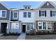 Charming townhome featuring a mix of light-colored siding, stone accents, and well-manicured landscaping at 6336 Granite Quarry Dr, Raleigh, NC 27610
