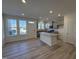 Well-lit kitchen showcases stainless steel appliances, a granite island, and a view from three large windows at 6336 Granite Quarry Dr, Raleigh, NC 27610