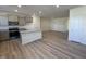 An open-concept kitchen with an island, granite countertops, stainless steel appliances and an open view at 6336 Granite Quarry Dr, Raleigh, NC 27610