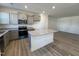 Bright kitchen featuring an island with granite countertops, stainless steel appliances, and ample cabinet space at 6336 Granite Quarry Dr, Raleigh, NC 27610