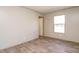 Bright bedroom with wood-look flooring and large window at 6545 Old Jefferson Davis Hwy, Cameron, NC 28326