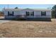 Single-wide manufactured home with gray siding, wood deck, and landscaping at 6545 Old Jefferson Davis Hwy, Cameron, NC 28326