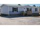 Gray single wide manufactured home with a wooden deck and spacious yard at 6545 Old Jefferson Davis Hwy, Cameron, NC 28326