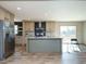 Open concept kitchen with island, stainless steel appliances, and light wood cabinets at 6545 Old Jefferson Davis Hwy, Cameron, NC 28326