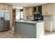 Modern kitchen featuring an island, stainless steel appliances, and light wood cabinets at 6545 Old Jefferson Davis Hwy, Cameron, NC 28326