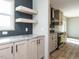Kitchen with light wood cabinets, granite countertops and floating shelves at 6545 Old Jefferson Davis Hwy, Cameron, NC 28326