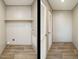 Laundry room with built-in shelving and vinyl flooring at 6545 Old Jefferson Davis Hwy, Cameron, NC 28326