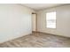 Spacious bedroom with wood-look flooring and an adjacent door at 6567 Old Jefferson Davis Hwy, Cameron, NC 28326