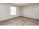 Spacious bedroom with large window and wood-look flooring at 6567 Old Jefferson Davis Hwy, Cameron, NC 28326