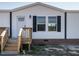 Close-up of the front entrance of a white manufactured home at 6567 Old Jefferson Davis Hwy, Cameron, NC 28326