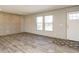 Bright living room with wood-look flooring and built-in shelving at 6567 Old Jefferson Davis Hwy, Cameron, NC 28326