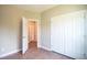 Well-lit bedroom featuring double door closet and wood-look floors at 105 Tracey Creek Ct Ct, Apex, NC 27502