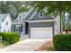 Gray house with white garage door and landscaping at 105 Tracey Creek Ct Ct, Apex, NC 27502
