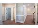 Hardwood floor hallway with white trim and doors at 105 Tracey Creek Ct Ct, Apex, NC 27502