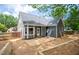 Gray house back, patio, fenced yard, and retaining wall at 105 Tracey Creek Ct Ct, Apex, NC 27502