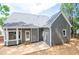 Gray house back with white trim, small patio, and fenced yard at 105 Tracey Creek Ct Ct, Apex, NC 27502