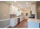 Modern kitchen with white cabinets, stainless steel appliances, and quartz countertops at 105 Tracey Creek Ct Ct, Apex, NC 27502