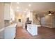 Modern kitchen with white cabinets, stainless steel appliances, and quartz countertops at 105 Tracey Creek Ct Ct, Apex, NC 27502