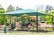 Shaded playground with climbing structures and slides at 105 Tracey Creek Ct Ct, Apex, NC 27502