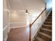 White railing staircase with carpeted steps and hardwood floors at 105 Tracey Creek Ct Ct, Apex, NC 27502