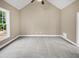 Simple bedroom with grey carpet and a large window at 1813 Ferrell Meadows Dr, Zebulon, NC 27597