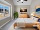 Virtually staged bedroom with large window and wood flooring at 1813 Ferrell Meadows Dr, Zebulon, NC 27597