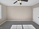 Well-lit bedroom with ceiling fan and gray carpeting at 1813 Ferrell Meadows Dr, Zebulon, NC 27597